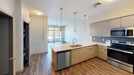 This contemporary 1-bedroom, 1-bathroom apartment in Phoenix offers 590 square feet of efficiently designed living space. The heart of the home is a modern, open-concept kitchen featuring light wood cabinetry, stainless steel appliances, and a striking mosaic tile backsplash. The kitchen flows seamlessly into a bright living area, accentuated by large windows that flood the space with natural light.

The bedroom, measuring 130 square feet, provides ample space and is equipped with a ceiling fan for comfort. Plush carpeting in the bedroom adds a cozy touch, while the main living areas boast attractive wood-look flooring. The bathroom is well-appointed with a full-sized tub, modern fixtures, and convenient grab bars.

Storage is thoughtfully incorporated throughout, including a dedicated closet space with built-in shelving. The apartment's neutral color palette and clean lines create a fresh, contemporary ambiance. Located at 290 E Roosevelt St in Phoenix, this urban dwelling combines style and functionality in a compact yet comfortable layout.