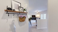 Located at 831 Pecan Ave in Winston-Salem, NC, this single-story, 2-bedroom, 2-bathroom home offers a well-designed layout with thoughtful details throughout. The entryway features a charming wall-mounted shelf with hooks, providing a functional and welcoming introduction to the space.

The open-concept kitchen and living area serves as the heart of the home. The kitchen is outfitted with gray cabinetry, stainless steel appliances, granite countertops, and a breakfast bar with seating — ideal for casual dining. Pendant lighting and recessed fixtures illuminate the space. The living area is carpeted and bright, with a ceiling fan and French doors that open to the patio, filling the room with natural light and providing easy outdoor access.

The spacious primary bedroom includes plush carpeting, a ceiling fan, and a walk-in closet. The second bedroom is equally well-appointed with soft carpet and a ceiling fan. Both bathrooms feature granite-topped vanities, with the second bathroom including a tub/shower combination and wood-look flooring.

Additional highlights include a dedicated laundry room with washer and dryer hookups and built-in shelving, three closets for ample storage, and a private patio. The home's neutral color palette and consistent finishes create a cohesive, comfortable atmosphere throughout.