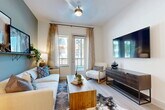This well-appointed one-bedroom, one-bathroom residence in Allen, TX offers a smart, efficient layout across a single floor. The open-concept living and dining area flows seamlessly into the kitchen, creating an inviting, connected space ideal for both relaxing and entertaining. The living room features light wood-tone flooring, a ceiling fan, and a glass door that floods the room with natural light while providing outdoor views. The kitchen is equipped with stainless steel appliances, gray shaker-style cabinetry, white quartz countertops, a decorative tile backsplash, and a peninsula with bar seating — perfect for casual dining. The bedroom is a comfortable retreat featuring plush carpet, a bold accent wall, large windows with ample natural light, and generous closet space. The full bathroom offers a gray vanity with quartz countertops, a lighted mirror, and a tub-shower combination, with direct access to the walk-in closet and in-unit laundry area. The dedicated laundry space includes a full-size Whirlpool washer and dryer. A pantry provides additional storage. Light wood-tone flooring runs throughout the main living areas, tying the space together with a clean, contemporary aesthetic.