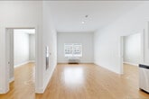 Located at 115 Main Street in Lincoln Park, NJ, this well-designed 2-bedroom, 1-bathroom residence offers a bright and functional single-level layout. The open living area greets you with warm hardwood-style flooring, crisp white walls, and soaring ceilings that enhance the sense of space. Natural light flows in through a large window, giving the room an airy, welcoming ambiance.

The kitchen is a standout feature, outfitted with sleek white cabinetry extending to ceiling height, light stone countertops, a textured tile backsplash, and a full suite of stainless steel appliances including a refrigerator, range, microwave, and dishwasher. The continuous hardwood flooring ties the kitchen seamlessly into the living space.

Both bedrooms are comfortably proportioned, each featuring hardwood flooring, neutral-toned walls, and windows that bring in natural light. The primary bedroom includes a generous walk-in closet with built-in wire shelving, while additional closets throughout the residence provide plentiful storage. A dedicated laundry area adds everyday convenience.

The bathroom is finished in a clean, all-white palette with tile flooring, a glass-enclosed shower, a floating vanity, and accessibility grab bars. Three closets in total round out the practical storage throughout this well-appointed residence.