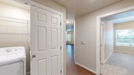 Located at 3213 S 28th Pl in Rogers, Arkansas, this single-floor home offers a well-designed layout with a cohesive, neutral aesthetic throughout. The kitchen serves as a functional centerpiece, featuring dark wood cabinetry, granite countertops, a peninsula island, and a full suite of stainless steel appliances including a refrigerator, range, and microwave. Recessed lighting and hardwood-style flooring complete the kitchen's clean, modern look.

The living areas continue the hardwood-style flooring and are bathed in natural light from multiple windows fitted with blinds. Ceiling fans are present throughout, providing both comfort and additional lighting. The bedrooms are finished with plush carpeting and include ceiling fans, adding a cozy feel to each room.

The bathrooms are consistently appointed with dark wood vanity cabinetry, white countertops, round mirrors, globe light fixtures, and tub/shower combos enclosed by sliding frosted glass doors. Wood-look flooring ties the bathrooms together with the rest of the home. A central hallway connects the main living spaces, bedrooms, and bathrooms, with six-panel white interior doors featured throughout. The overall ambiance is clean, neutral, and move-in ready.