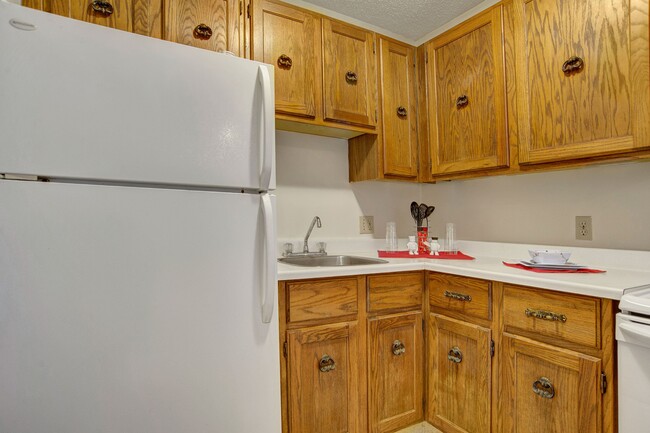 A kitchen with white appliances and light cabinetry - Madison Park