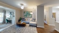 Located at 12226 Toscana Way in Charlotte, NC, this single-story residence offers a thoughtfully designed layout with modern finishes throughout. The kitchen is outfitted with white shaker-style cabinetry, quartz countertops, a subway tile backsplash, stainless steel appliances including a range and over-the-range microwave, and a deep single-basin sink — all set atop durable wood-style flooring. The open layout connects seamlessly to a dining area accented by crown molding, chair rail detailing, and a curated gallery wall, as well as a living room featuring crown molding and a ceiling light fixture.

The primary bedroom is generously sized with a ceiling fan, carpet flooring, and French doors opening to a private balcony. Its en-suite bathroom offers dual sinks, white cabinetry, a wide vanity mirror, and wood-style flooring. A secondary bedroom features an accent wall and ample natural light. A shared bathroom includes a soaking tub with shower combination. A dedicated laundry area houses a full-size washer and dryer with built-in shelving, adding practical convenience to this well-rounded home.