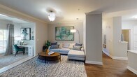Located at 12226 Toscana Way in Charlotte, NC, this single-story residence offers a thoughtfully designed layout with modern finishes throughout. The kitchen is outfitted with white shaker-style cabinetry, quartz countertops, a subway tile backsplash, stainless steel appliances including a range and over-the-range microwave, and a deep single-basin sink — all set atop durable wood-style flooring. The open layout connects seamlessly to a dining area accented by crown molding, chair rail detailing, and a curated gallery wall, as well as a living room featuring crown molding and a ceiling light fixture.

The primary bedroom is generously sized with a ceiling fan, carpet flooring, and French doors opening to a private balcony. Its en-suite bathroom offers dual sinks, white cabinetry, a wide vanity mirror, and wood-style flooring. A secondary bedroom features an accent wall and ample natural light. A shared bathroom includes a soaking tub with shower combination. A dedicated laundry area houses a full-size washer and dryer with built-in shelving, adding practical convenience to this well-rounded home.