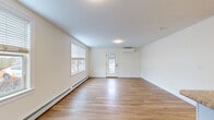 Located at Island View Drive in Westbrook, Maine, this single-floor, one-bedroom, one-bathroom unit offers a thoughtfully designed layout across a compact but efficient footprint. The open-plan living room and kitchen area forms the heart of the unit, characterized by light-toned hardwood-style flooring, crisp white walls, and multiple windows fitted with horizontal blinds that allow generous natural light throughout the space. A wall-mounted mini-split system provides efficient heating and cooling, complemented by baseboard heaters along the perimeter walls.

The kitchen is well-equipped with white cabinetry, granite-style countertops, stainless steel appliances including a refrigerator, electric range, over-the-range microwave, and dishwasher, along with a peninsula that provides additional counter space and a casual dining option.

The bedroom is carpeted for comfort, features a window with natural light, a baseboard heater, and a dedicated closet with bifold doors and built-in hanging rods. An additional closet provides further storage. The bathroom includes a white vanity with ample cabinet storage, a tub-shower combination, wood-look flooring, and bronze-toned hardware fixtures throughout.