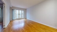 Located at 20 York St in Ottawa's vibrant Lowertown neighbourhood, this well-laid-out one-bedroom, one-bathroom unit offers a functional and comfortable living environment across a single floor. Warm hardwood flooring flows throughout the main living areas, creating a cohesive and inviting atmosphere.

The open-concept kitchen and living room area forms the heart of the unit. The kitchen features warm wood cabinetry, granite-style countertops, a double stainless steel sink, a dishwasher, electric range, and a full-size refrigerator — providing ample storage and workspace. A peninsula counter separates the kitchen from the living area, which is bathed in natural light through a large sliding glass door and window overlooking the exterior.

The bedroom is a comfortable, well-proportioned room with hardwood flooring, a large window that brings in natural light, and a dedicated double-door closet for storage. Neutral grey walls throughout lend the space a clean, modern feel.

The full bathroom is finished with light ceramic tile flooring, a wood vanity with granite-style countertop, a large mirror, and a full tub and shower surround with beige tile. A hallway with additional closet space connects the rooms efficiently, completing this practical and well-maintained Ottawa residence.