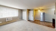 Located at 2800 Welsh Rd in Philadelphia's 19152 zip code, this single-floor unit offers a practical and well-maintained layout designed for comfortable everyday living. The open-concept living and dining area features plush carpeting, neutral gray walls, and a ceiling fan, creating a relaxed and inviting atmosphere. A large window with vertical blinds allows natural light to fill the space, while a front entry closet provides convenient storage.

The kitchen is a functional highlight, equipped with crisp white shaker-style cabinetry, dark granite-style countertops, and a classic tile backsplash. It includes a full suite of appliances — an electric range, stainless steel refrigerator, built-in microwave, and dishwasher — all set over durable hardwood-style flooring that transitions cleanly from the carpeted living area.

The bedrooms are generously sized, each finished with soft carpeting and neutral tones. Multiple windows fitted with blinds bring in natural light, and several rooms include wall-mounted heating and cooling units for individual climate control. The bathroom features a full-size soaking tub with a shower, surrounded by clean white subway tile, offering a simple and timeless aesthetic. Overall, the unit presents a clean, move-in-ready environment well-suited for daily living.
