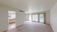 Located in Lapeer, Michigan, this single-floor, 3-bedroom, 2-bathroom home offers a practical and well-organized layout. The living area is a standout feature, highlighted by expansive floor-to-ceiling sliding glass doors dressed with vertical blinds that fill the room with natural light and provide views of the surrounding greenery. Soft, neutral carpeting runs throughout the main living spaces, lending a warm and comfortable feel.

The dining room sits adjacent to the living area and features its own sliding glass door for additional natural light, accented by a classic chandelier overhead. The kitchen is efficiently designed with light-toned cabinetry featuring wood trim accents, a coil-top electric range, a stainless steel sink, and a window overlooking the outdoors, creating a bright cooking environment.

The spacious primary bedroom offers generous square footage and connects conveniently to one of the two bathrooms, which features a wide vanity with dual medicine cabinets and ample counter space. The two additional bedrooms are well-proportioned with carpeted floors and warm wood-toned doors. A hallway connects all bedrooms and bathrooms, ensuring a logical and comfortable flow throughout the home. The entrance provides a welcoming transition into this neatly laid-out residence.