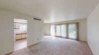 Located in Lapeer, Michigan, this single-floor, 3-bedroom, 2-bathroom home offers a practical and well-organized layout. The living area is a standout feature, highlighted by expansive floor-to-ceiling sliding glass doors dressed with vertical blinds that fill the room with natural light and provide views of the surrounding greenery. Soft, neutral carpeting runs throughout the main living spaces, lending a warm and comfortable feel.

The dining room sits adjacent to the living area and features its own sliding glass door for additional natural light, accented by a classic chandelier overhead. The kitchen is efficiently designed with light-toned cabinetry featuring wood trim accents, a coil-top electric range, a stainless steel sink, and a window overlooking the outdoors, creating a bright cooking environment.

The spacious primary bedroom offers generous square footage and connects conveniently to one of the two bathrooms, which features a wide vanity with dual medicine cabinets and ample counter space. The two additional bedrooms are well-proportioned with carpeted floors and warm wood-toned doors. A hallway connects all bedrooms and bathrooms, ensuring a logical and comfortable flow throughout the home. The entrance provides a welcoming transition into this neatly laid-out residence.