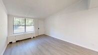 Located at 4110 Mountain Creek Rd in Chattanooga, TN, this single-floor, one-bedroom, one-bathroom unit offers a clean and efficiently designed layout. Throughout the space, light wood-style laminate flooring and a crisp white color palette create a bright, cohesive aesthetic.

The open living and kitchen area serves as the heart of the unit. The kitchen features white cabinetry, a white electric range, a refrigerator, and a sink with light-toned countertops, all accented by under-cabinet lighting. A textured ceiling adds dimension to the space. The living area provides an open feel with clean walls and easy access to the bedroom via a hallway.

The bedroom is a comfortable, well-proportioned room equipped with a ceiling fan with light fixture, a window offering views of surrounding greenery, and a standard closet. Natural light filters in through blinds, lending the room a pleasant brightness.

The bathroom is neatly appointed with a white vanity, a tub-shower combination, and light flooring that ties in with the rest of the unit. A utility room rounds out the floor plan, providing practical additional storage or laundry space.

Overall, this unit presents a tidy, move-in-ready space with consistent finishes, functional rooms, and a clean, understated design well-suited for comfortable everyday living.