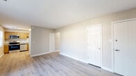 This two-bedroom, two-bathroom residence in Columbus, Indiana offers a well-designed single-floor layout with a clean, modern aesthetic throughout. Light-toned wood-look flooring flows continuously across the entire space, creating a cohesive and easy-to-maintain foundation in every room.

The open-concept living and kitchen area forms the heart of the home. The living room features a large sliding glass door dressed with vertical blinds, allowing generous natural light and outdoor access. The kitchen is well-appointed with warm honey-toned wood cabinetry, granite-style countertops, and a full suite of stainless steel appliances including a range, microwave, dishwasher, and refrigerator — offering both style and function.

The primary bedroom is a comfortable, well-proportioned retreat featuring neutral warm-gray walls, a closet, and additional door access. The second bedroom benefits from a window that invites natural light, brightening the neutral tones of the room. Both bedrooms offer generous closet storage, complemented by additional closets found throughout the unit.

Each bathroom is finished with wood-toned vanities, granite-style countertops, brushed nickel fixtures, and a tub-shower combination. The unit also includes a dedicated laundry area and utility room, adding everyday convenience to this thoughtfully laid-out residence.