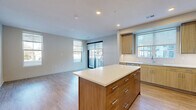 Located at 4210 Shawnee Mission Pkwy in Fairway, KS, this modern 2-bedroom, 4-bathroom residence offers a thoughtfully designed single-floor layout. The open-concept great room seamlessly integrates the living, dining, and kitchen areas, creating a bright and cohesive space bathed in natural light from multiple large windows. The kitchen is a standout feature, equipped with light wood cabinetry, stainless steel appliances including a refrigerator, microwave, and dishwasher, and a central island with a crisp white countertop — ideal for both meal preparation and casual dining. Light wood-style flooring flows throughout the main living areas, adding warmth and continuity. A sliding glass door connects the living area to a private patio, offering convenient outdoor access. The two bedrooms feature plush carpeting and large windows that invite natural light and outdoor views. The primary bedroom is generously sized and well-appointed. The four bathrooms are finished with elegant large-format tile, glass-enclosed walk-in showers with built-in benches, and wood-toned vanity cabinetry. Additional spaces include a dedicated laundry room, utility room, entrance foyer, and two closets, ensuring ample storage throughout.