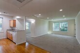 Located at 604 S Fair Oaks Ave in Sunnyvale, California, this well-appointed two-bedroom, one-bathroom residence offers a comfortable and functional single-floor layout. The open-concept living and kitchen area forms the heart of the home, where a breakfast bar with granite-style countertops connects the two spaces seamlessly. The kitchen is equipped with warm wood cabinetry, a full suite of white appliances including a refrigerator, range, microwave, and dishwasher, complemented by hardwood-style flooring and a window that brings in natural light. The spacious living room features plush carpeting, recessed lighting, crown molding, and a large window with leafy outdoor views, creating a bright and welcoming atmosphere. Both bedrooms are carpeted and well-lit with natural light from generously sized windows; the primary bedroom offers ample space and closet storage. The bathroom is finished with granite-style surfaces, a combined tub and shower with a stone-surround enclosure, and a wood-toned vanity. A private balcony enclosed with horizontal wood paneling provides a quiet outdoor retreat with views of surrounding greenery, completing this comfortable Sunnyvale residence.