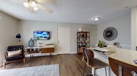 Located at 3978 75th St W in Bradenton, Florida, this single-story residence offers a well-designed open-concept layout that seamlessly connects the kitchen, dining, and living areas. The kitchen is outfitted with stainless steel appliances, white cabinetry, and a granite-topped island with an undermount sink and bar seating — an ideal setup for both everyday cooking and casual entertaining. Wood-style flooring runs throughout the main living areas, lending warmth and continuity to the space.

The living room is bright and inviting, anchored by a sliding glass door that fills the room with natural light and provides access to an outdoor area. A ceiling fan adds comfort, while neutral wall tones create a versatile backdrop. The bedroom features plush carpeting, generous natural light through wide windows with blinds, and access to a walk-in closet, offering practical storage. The bathroom includes a tub-shower combination with white tile surround, a granite vanity countertop, and wood-style flooring. A dedicated laundry area is conveniently accessible from the kitchen. Overall, the space presents a clean, functional, and comfortable living environment.