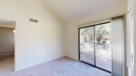 Located at 4400 E Busby Dr in Sierra Vista, Arizona, this single-floor residence offers four bedrooms, one bathroom, and a kitchen connected by a central hallway. The layout is straightforward and practical, making efficient use of the available floor space.

The bedrooms are finished with neutral-toned carpet and bright white walls, creating a clean and versatile environment. Several rooms feature windows that bring in natural light and offer views of the surrounding desert landscape and neighboring structures. The primary bedroom is notably spacious, includes a sliding-door closet for storage, and provides direct access to an outdoor patio or balcony through a glass sliding door. Additional bedrooms are similarly well-lit with window access to natural light.

The galley-style kitchen is efficiently organized with white cabinetry lining both walls, offering ample storage and counter space. It is equipped with a full suite of white appliances, including a range, microwave, dishwasher, and refrigerator, all set above warm hardwood-style flooring that extends into the adjacent dining or flex area.

The bathroom features a full tub-and-shower combination with clean white tile surround and chrome fixtures. Throughout the space, the light-filled, neutral aesthetic provides a versatile and move-in ready living environment in the heart of Sierra Vista.