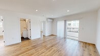 Located at 1185 Myra Ave in Los Angeles, this thoughtfully designed 2-bedroom, 2-bathroom residence offers a clean, modern aesthetic throughout. Light wood-tone flooring flows seamlessly across the entire unit, complementing the crisp white walls and recessed lighting that create a bright, welcoming atmosphere.

The open-plan living and dining area is generously proportioned, anchored by a wall-mounted mini-split system for year-round comfort and sliding glass doors that lead to a private balcony, filling the space with natural light and outdoor views. A stacked in-unit washer and dryer is conveniently integrated near the main living area.

The galley-style kitchen is well-appointed with white shaker cabinetry, black hardware accents, stainless steel appliances including a gas range, dishwasher, and built-in microwave, plus a subway tile backsplash and ample counter space.

Both bedrooms are well-sized with clean white walls, wood flooring, and dedicated closets. The second bedroom benefits from a wide window with neighborhood views. Both bathrooms feature a consistent design language: white subway tile walls, hexagonal dark tile flooring, white vanities with black fixtures, and soaking tub-shower combinations. The overall ambiance is clean, contemporary, and move-in ready.