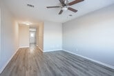 Located at Tennessee Avenue in Warner Robins, Georgia, this single-story home offers five bedrooms, one bathroom, a kitchen, and two connecting hallways, all arranged within a compact and efficiently organized floor plan. Throughout the home, light wood-look luxury vinyl plank flooring provides a clean, cohesive aesthetic that complements the neutral warm and cool gray wall tones present across the rooms.

The five bedrooms vary in size, with the primary bedroom offering the most generous dimensions. Several bedrooms receive natural light through horizontal windows fitted with blinds, while one bedroom features built-in shelving within a dedicated closet, adding practical storage. Each bedroom includes standard electrical outlets and benefits from the consistent flooring found throughout the home.

The kitchen is equipped with white cabinetry, granite-style countertops, a white electric range, a dishwasher, and a full-size refrigerator. Crown molding accents the kitchen ceiling, and a door with a window provides additional light and exterior access.

The bathroom features white subway tile surrounding a full bathtub and shower, a pedestal sink, a toilet, a mirrored medicine cabinet, and wood-look flooring. The hallways connect the rooms fluidly, contributing to the home's straightforward, functional layout.