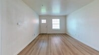 This 840 square foot apartment in Oklahoma City offers a practical and contemporary living space. The layout comprises two bedrooms, including a primary bedroom of 170 square feet, and two full bathrooms. The single-floor design maximizes space efficiency.

The kitchen is a highlight, featuring sleek white cabinetry, stainless steel appliances, and recessed lighting. It opens to a living area with wood-look flooring, creating a seamless flow for entertaining. Large windows in the living room and bedrooms allow for natural light, while ceiling fans provide comfort and air circulation.

Both bathrooms are equipped with modern fixtures, including a shower/tub combination with built-in shelving. The bedrooms feature plush carpeting and closets with ample storage space. Additional storage solutions are found throughout the apartment.

The neutral color palette, predominantly white walls, and mix of carpeted and wood-look flooring create a clean, contemporary aesthetic. This apartment offers a balanced combination of functionality and modern design, ideal for those seeking a compact yet well-appointed living space in Oklahoma City.