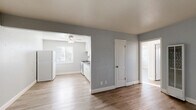 Located in Arden-Arcade, Sacramento, this 2-bedroom, 1-bathroom unit offers a well-organized single-floor layout designed for comfortable everyday living. Light wood-tone flooring flows consistently throughout, complementing cool gray walls and bright white trim that give the home a clean, modern aesthetic.

The living room provides a welcoming entry point with ample space, while an open pass-through connects it to the combined dining area and kitchen. The kitchen is well-appointed with white shaker-style cabinetry, a gray countertop, a single-basin sink, a gas range, and a full-size refrigerator. A ceiling fan and a window with blinds keep the space bright and airy.

Both bedrooms are comfortably sized, with the primary bedroom offering corner windows that invite generous natural light and an overhead ceiling fan. The second bedroom also features a ceiling fan, a window with blinds, and access to a closet. Three closets in total provide practical storage throughout the unit.

The bathroom includes a full vanity with under-sink storage and a shower-tub combination with tiled surrounds and a window for natural ventilation. A hallway connects the main living areas to the bedrooms and bathroom, adding a sense of separation and privacy. The overall ambiance is bright, clean, and move-in ready.
