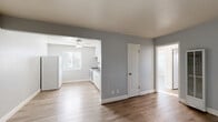 Located in Arden-Arcade, Sacramento, this 2-bedroom, 1-bathroom unit offers a well-organized single-floor layout designed for comfortable everyday living. Light wood-tone flooring flows consistently throughout, complementing cool gray walls and bright white trim that give the home a clean, modern aesthetic.

The living room provides a welcoming entry point with ample space, while an open pass-through connects it to the combined dining area and kitchen. The kitchen is well-appointed with white shaker-style cabinetry, a gray countertop, a single-basin sink, a gas range, and a full-size refrigerator. A ceiling fan and a window with blinds keep the space bright and airy.

Both bedrooms are comfortably sized, with the primary bedroom offering corner windows that invite generous natural light and an overhead ceiling fan. The second bedroom also features a ceiling fan, a window with blinds, and access to a closet. Three closets in total provide practical storage throughout the unit.

The bathroom includes a full vanity with under-sink storage and a shower-tub combination with tiled surrounds and a window for natural ventilation. A hallway connects the main living areas to the bedrooms and bathroom, adding a sense of separation and privacy. The overall ambiance is bright, clean, and move-in ready.