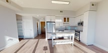 This contemporary apartment, located at 8300 Wisconsin Ave in Bethesda, MD, offers 1020 square feet of thoughtfully designed living space. The unit boasts three bedrooms, including a spacious primary bedroom of 170 square feet, and four bathrooms, providing ample privacy and convenience for residents and guests alike.

The heart of the home is an open-concept kitchen and living area, showcasing a sleek, modern design. The gourmet kitchen features white cabinetry, stainless steel appliances, and granite countertops, complemented by a functional kitchen island. Large windows flood the space with natural light and offer stunning city views, creating an airy and inviting atmosphere.

Throughout the apartment, light-toned hardwood floors enhance the sense of spaciousness and contribute to the overall modern aesthetic. The bathrooms are elegantly appointed with neutral tones and contemporary fixtures, including a combination of shower-tub units and stand-alone showers.

The bedrooms are well-proportioned and bathed in natural light, with the primary bedroom offering a generous 170 square feet of space. Built-in closets provide ample storage solutions. The apartment's single-floor layout ensures easy accessibility and flow between rooms.

This urban residence strikes a perfect balance between style and functionality, ideal for those seeking a contemporary living space in the heart of Bethesda.