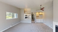 Located at 3280 SW 170th Ave in Beaverton, Oregon, this single-floor apartment offers two bedrooms and two bathrooms within a well-designed layout. The living room serves as the heart of the home, featuring a fireplace and large sliding glass doors that open to a private wooden deck with outdoor views of the surrounding neighborhood and greenery, filling the space with natural light.

The kitchen is equipped with stainless steel appliances, including a refrigerator, electric range, microwave, and dishwasher. White shaker-style cabinetry, light quartz countertops, a tile backsplash, and hardwood-style flooring give the kitchen a clean, modern aesthetic. A peninsula with an undermount sink adds both functionality and a convenient serving area.

Both bedrooms are carpeted and feature neutral gray walls, white trim, and baseboard heating. The primary bedroom is generously sized, while the second bedroom offers comfortable proportions with a window overlooking the outdoors. A hallway connects the bedrooms to the two bathrooms, one of which includes a tub/shower combination, and another fitted with grab bars and practical fixtures. An in-unit stacked washer and dryer is also conveniently accessible from the bedroom hallway. A dedicated closet provides additional storage throughout this efficiently organized home.