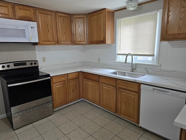 Large kitchen w/ quartz counters, new appliances, and 2 fridges. - 12105 12th Ave S