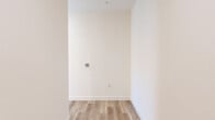 Located on the fourth floor at 2968 W 7th St in Los Angeles' vibrant Koreatown neighborhood, this modern 2-bedroom, 2-bathroom residence offers a clean, contemporary design throughout. Light wood-tone flooring flows seamlessly across the open living and bedroom areas, creating a bright and cohesive aesthetic.

The kitchen is a standout feature, finished with high-gloss white cabinetry, a quartz countertop with stone-veined detailing, a subway tile backsplash, and a full suite of stainless steel appliances including a gas range, built-in microwave, and French door refrigerator. An in-unit stacked washer and dryer adds everyday convenience.

Both bedrooms are well-proportioned and filled with natural light from large sliding windows that frame city views of the Los Angeles skyline and surrounding urban landscape. The primary bedroom includes a dedicated closet with built-in shelving for organized storage.

The two bathrooms are finished with neutral large-format floor tiles and full tub-shower combinations with floor-to-ceiling tile surrounds. The primary bath features a sleek vanity with an LED-backlit mirror, adding a modern touch. The overall palette throughout the residence is clean and neutral, lending a bright, move-in-ready ambiance ideal for urban living.