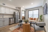 Located at 5811 Poplar Avenue in Memphis, TN, this thoughtfully designed one-bedroom, two-bathroom unit offers a modern and cohesive aesthetic throughout its efficiently organized single floor. Light wood-tone flooring runs continuously throughout the space, creating a warm and unified foundation.

The open living area is anchored by large windows with slatted blinds that invite generous natural light, offering a bright and airy atmosphere. The kitchen is sleek and functional, featuring crisp white cabinetry, light countertops, and a full suite of stainless steel appliances including a refrigerator, dishwasher, electric range, and built-in microwave.

The bedroom is a comfortable retreat, complete with a ceiling fan, a window for natural light, and easy access to the hallway. A hallway connects the bedroom to the two bathrooms, one of which features marble-style tile surround on a full soaking tub and shower combination with chrome fixtures, providing a clean and polished look.

A hallway with a sliding panel door adds practical storage and smooth traffic flow between spaces. Neutral wall tones throughout complement the modern finishes, contributing to a calm, contemporary ambiance well-suited for everyday living.