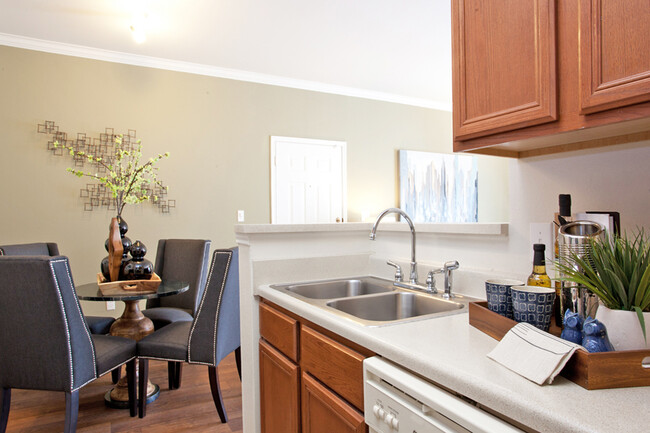 Kitchen with light brown cabinets and white appliances - Indigo Pointe