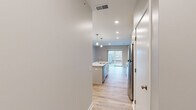 Located at 2329 SE Timberbrook Dr in Grand Rapids, MI, this well-appointed one-bedroom, one-bathroom unit offers a thoughtfully designed layout with modern finishes throughout. Light-toned hardwood flooring flows seamlessly across the entire space, creating a bright and cohesive aesthetic.

The open-concept kitchen serves as the heart of the unit, anchored by a central island with a white quartz countertop, undermount sink, and pendant lighting above. Shaker-style cabinetry in soft white provides ample storage, complemented by a classic subway tile backsplash and a full suite of stainless steel appliances, including a refrigerator, range, and over-the-range microwave. A sliding glass door at the end of the kitchen area brings in natural light and connects to an outdoor space.

The bedroom is comfortably sized with large windows dressed in white blinds that allow for generous natural light and outdoor views of the surrounding landscape. A dedicated walk-in closet with wire shelving on multiple walls provides excellent storage capacity.

The bathroom features a full tub-shower combination, a clean white vanity with a quartz top, and wood-look flooring that ties in with the rest of the unit. Recessed lighting and a neutral gray-and-white palette throughout give the space a clean, contemporary feel.