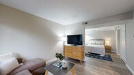 Located at 191 Spencer St in Manchester, CT, this well-designed one-bedroom, one-bathroom unit makes smart use of its compact footprint across a single floor. The open-concept living area features hardwood-style flooring that runs throughout, neutral warm-gray walls, and windows with slatted blinds that allow natural light to filter in. The living room provides a comfortable lounge space that flows seamlessly into a dedicated dining nook, where a pendant light centers over a dining area with a window view. The kitchen is efficiently laid out with dark espresso cabinetry, dark granite-style countertops, a stainless steel sink, and full black appliance suite including a refrigerator, stove, and microwave. The bedroom offers a calm, restful retreat with soft neutral tones, hardwood-style flooring, and ample space for a queen-sized bed. A louvered closet door provides convenient storage access. The bathroom features a clean, modern vanity with a vessel sink, dark countertop, and white cabinetry, complemented by recessed lighting. Throughout the unit, the consistent use of neutral tones, updated finishes, and wood-look flooring creates a cohesive and functional living environment.