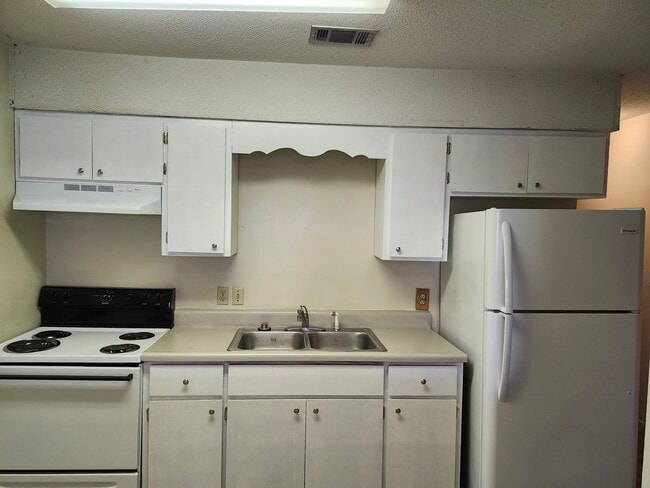 Kitchen with newly refinished cabinets and counter top - 44 5th Ave
