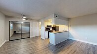 Located at 4216 S Manhattan Ave in Tampa, FL, this efficiently designed single-floor unit makes smart use of its compact footprint. The open-concept layout seamlessly connects the living, dining, and kitchen areas into one cohesive space, creating a sense of openness and versatility. Wood-look vinyl plank flooring runs throughout the unit, lending a warm, contemporary feel, while a textured ceiling adds architectural character. A ceiling fan in the main living area promotes year-round comfort.

The kitchen is thoughtfully arranged with white cabinetry, a warm wood-tone countertop, and a peninsula that defines the cooking space from the living area. Black appliances — including a gas range, over-the-range microwave, and refrigerator — complete the kitchen. A skylight-style overhead light fixture provides additional brightness. A window in the main living area allows natural light to filter in, offering a view of the surrounding greenery.

The bathroom features a full tub-shower combination, a white vanity with storage, and the same wood-look flooring for a cohesive look. Two closets provide practical storage solutions. The unit's clean, neutral palette and updated finishes make it a functional and inviting space in the South Tampa area.