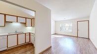 Located at 2803 Taos Dr in Miamisburg, Ohio, this single-floor, 2-bedroom, 3-bathroom home offers a well-organized layout with a variety of functional spaces. The open living and dining areas are connected seamlessly, featuring warm wood-look flooring, vaulted ceilings, and generous natural light streaming through large windows. A ceiling fan adds comfort to the living space, which also features a charming pass-through window connecting to the kitchen. The kitchen is efficiently designed with white cabinetry accented by wood-tone trim, white appliances including a dishwasher and range, a double sink, and ample counter space arranged in an L-shaped layout. Both bedrooms are carpeted and well-lit by natural light from exterior windows, with the generously sized primary bedroom featuring a ceiling fan. The three bathrooms each include a tub-shower combination with clean white surrounds and wood-look flooring. Additional spaces include a utility room, hallway, and two closets that provide practical storage throughout. The textured ceilings and neutral wall tones create a consistent, clean aesthetic across the home, offering a move-in-ready environment with a comfortable, functional feel.