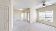 This 670 square foot, single-floor apartment offers a thoughtfully designed living space. The primary bedroom, measuring 120 square feet, provides ample room and includes a large walk-in closet with built-in shelving for optimal organization. The living area is bright and airy, featuring plush carpeting and a ceiling fan for comfort. Large windows allow natural light to flood the space, creating an open and inviting atmosphere.

The kitchen boasts a modern design with sleek gray cabinetry, granite countertops, and stainless steel appliances, including a built-in microwave. Wood-look vinyl flooring in the kitchen and bathroom adds warmth and durability. The bathroom showcases a contemporary vanity with ample storage and a large mirror, complemented by stylish lighting fixtures.

Throughout the apartment, neutral wall colors provide a blank canvas for personalization. The overall layout maximizes the use of space, offering a harmonious blend of comfort and functionality. With its updated features and efficient design, this apartment presents an ideal living solution for those seeking a modern, low-maintenance home.