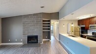 Located at 1535 Weymouth Cir in Westlake, Ohio, this 2-bedroom, 2-bathroom single-floor home offers a thoughtfully designed layout with modern updates throughout. The open-concept living area serves as the heart of the home, highlighted by a striking floor-to-ceiling tiled fireplace with a sleek surround and built-in shelving on an adjacent accent wall. Large sliding glass doors flood the space with natural light and provide outdoor access. Durable wood-look flooring runs through the main living areas, adding warmth and continuity.

The kitchen is well-equipped with rich dark cabinetry, stainless steel appliances, a tile backsplash, and a peninsula with a white countertop and undermount sink, illuminated by pendant lighting. A dedicated dining area with chair rail molding and a ceiling fan sits adjacent, creating a natural flow for daily living.

Both bedrooms feature plush carpeting and windows that bring in natural light, with the primary bedroom offering generous proportions and closet access. The two bathrooms are finished with dark wood vanities, granite-style countertops, framed mirrors, and light wood-look tile flooring. A hallway and closet round out the efficient, functional floor plan.