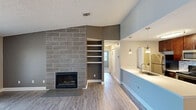Located at 1535 Weymouth Cir in Westlake, Ohio, this 2-bedroom, 2-bathroom single-floor home offers a thoughtfully designed layout with modern updates throughout. The open-concept living area serves as the heart of the home, highlighted by a striking floor-to-ceiling tiled fireplace with a sleek surround and built-in shelving on an adjacent accent wall. Large sliding glass doors flood the space with natural light and provide outdoor access. Durable wood-look flooring runs through the main living areas, adding warmth and continuity.

The kitchen is well-equipped with rich dark cabinetry, stainless steel appliances, a tile backsplash, and a peninsula with a white countertop and undermount sink, illuminated by pendant lighting. A dedicated dining area with chair rail molding and a ceiling fan sits adjacent, creating a natural flow for daily living.

Both bedrooms feature plush carpeting and windows that bring in natural light, with the primary bedroom offering generous proportions and closet access. The two bathrooms are finished with dark wood vanities, granite-style countertops, framed mirrors, and light wood-look tile flooring. A hallway and closet round out the efficient, functional floor plan.