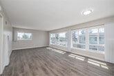 Located on Crenshaw Blvd in Inglewood, CA, this well-appointed 2-bedroom, 1-bathroom residence offers a thoughtfully designed single-floor layout with a bright, neutral palette throughout. The open living room is a standout space, featuring wide-plank light wood flooring and expansive windows that flood the room with natural sunlight and frame views of the surrounding neighborhood's mature trees and streetscape. The adjoining kitchen is fitted with white cabinetry, tile countertops with a subway tile backsplash, a double-basin sink, and tile flooring, providing ample storage and functionality. Both bedrooms are carpeted and feature ceiling fans, vertical blinds, and generous sliding-door closets — the primary bedroom boasting a wide double-wide closet wall, while the second bedroom includes its own sizable storage closet. The bathroom is clean and efficiently designed, featuring tile flooring, a wood-grain vanity with a wall-mounted mirror, and a frosted window for natural light and privacy. A connecting hallway ties all rooms together seamlessly. The overall ambiance is light, airy, and move-in ready, with consistent neutral tones and modern touches throughout.