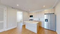 Located at 39 Lexington Ave in Passaic, NJ, this well-appointed 3-bedroom, 2-bathroom residence offers a thoughtfully designed single-floor layout with modern finishes throughout. Light wood-tone flooring flows seamlessly across every room, lending warmth and continuity to the space.

The open-concept kitchen and living area serves as the heart of the home. The kitchen is equipped with stainless steel appliances including a gas range, built-in microwave, and a French door refrigerator. Light wood cabinetry reaches to the ceiling, complemented by white quartz countertops, a subway tile backsplash, and a central island that doubles as additional prep and dining space.

The living area receives abundant natural light through a large picture window with views of the surrounding Passaic streetscape. Each of the three bedrooms features light-filled windows, neutral walls, and clean white shaker-style doors with modern hardware.

Both bathrooms are finished in a contemporary style, featuring floating wood-grain vanities, backlit LED mirrors, and sleek matte black fixtures. One bathroom includes a tiled tub-shower combination, while the second offers a glass-enclosed shower.

Throughout the residence, recessed lighting, white panel doors, and a clean, neutral palette create a bright, modern ambiance ideal for comfortable everyday living.