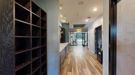 Located at 101 Summit St in Duluth, MN, this single-floor amenity facility offers a thoughtfully designed wellness and recreation experience across a spacious footprint of seven distinct areas. The interior is unified by warm wood-look flooring, teal accent walls, and contemporary finishes that create a cohesive, inviting atmosphere throughout.

The centerpiece of the facility is a large indoor pool featuring a warm wood-paneled ceiling, expansive windows that flood the space with natural light and outdoor views, decorative blue tile accents, and poolside lounge seating. A basketball hoop adds a recreational element to the pool area. Adjacent to the pool, a sauna enclosure and open deck space complete the aquatic zone.

A dedicated fitness studio features polished hardwood floors, bold red acoustic ceiling panels, mirrored walls, a projection screen, and an array of exercise equipment — well-suited for group classes or individual workouts.

A serene spa treatment room provides a calming retreat, appointed with soft lighting, candlelight ambiance, and a sheer curtain backdrop with delicate fairy lights for a relaxing atmosphere.

The corridors and entry areas are finished with rich wood cabinetry, built-in shelving, and modern pendant lighting. The exterior features a brick façade with large grid windows, a paved outdoor patio with lounge chairs, and landscaped grounds with mature trees.