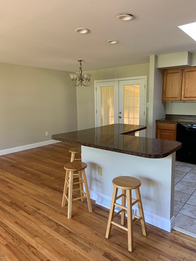 Full dining room off the kitchen with French doors to the porch - 900 Tottenham Dr