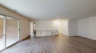 Located at 1113 Wheatland Ave in Lancaster, PA, this well-appointed 3-bedroom, 2-bathroom home offers a thoughtfully designed single-floor layout with generous living space. The main living area features hardwood-style flooring, neutral tones, and sliding glass doors that open to a private balcony with outdoor views, flooding the room with natural light. An elegant wrought iron railing defines the staircase, adding a refined architectural touch to the open layout.

The dining room is bright and inviting, centered around a classic chandelier and framed by large windows that offer pleasant neighborhood views. It connects seamlessly to the kitchen, which is equipped with warm wood shaker-style cabinetry, granite countertops, a white tile backsplash, and hardwood-style flooring — a functional and stylish space for cooking and entertaining.

The three bedrooms are carpeted for comfort, each offering ample natural light. The spacious primary bedroom includes a walk-in closet and dedicated storage. The two bathrooms are finished with wood-toned vanities, white countertops, and marble-look tile flooring, with a clean walk-in shower in one. Three closets throughout the home ensure excellent storage. The hallway connects all spaces efficiently, completing this comfortable and cohesive home.