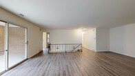 Located at 1113 Wheatland Ave in Lancaster, PA, this well-appointed 3-bedroom, 2-bathroom home offers a thoughtfully designed single-floor layout with generous living space. The main living area features hardwood-style flooring, neutral tones, and sliding glass doors that open to a private balcony with outdoor views, flooding the room with natural light. An elegant wrought iron railing defines the staircase, adding a refined architectural touch to the open layout.

The dining room is bright and inviting, centered around a classic chandelier and framed by large windows that offer pleasant neighborhood views. It connects seamlessly to the kitchen, which is equipped with warm wood shaker-style cabinetry, granite countertops, a white tile backsplash, and hardwood-style flooring — a functional and stylish space for cooking and entertaining.

The three bedrooms are carpeted for comfort, each offering ample natural light. The spacious primary bedroom includes a walk-in closet and dedicated storage. The two bathrooms are finished with wood-toned vanities, white countertops, and marble-look tile flooring, with a clean walk-in shower in one. Three closets throughout the home ensure excellent storage. The hallway connects all spaces efficiently, completing this comfortable and cohesive home.