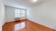 Located at 103 S Wood Ave in Linden, NJ, this one-bedroom, one-bathroom unit offers a thoughtfully designed layout that makes efficient use of its space. Warm hardwood flooring flows throughout the main living areas, creating a cohesive and inviting ambiance.

The kitchen is a standout feature, outfitted with gray shaker-style cabinetry, white quartz countertops, a subway tile backsplash, and a full suite of stainless steel appliances including a range, microwave, dishwasher, and refrigerator. A peninsula with an integrated sink adds both workspace and a natural boundary between the kitchen and the adjacent dining area.

The living and dining areas benefit from natural light streaming through windows fitted with blinds, keeping the space bright and airy. The bedroom is a well-proportioned retreat with hardwood floors, a window with outdoor views, and a wall-unit HVAC system.

The bathroom is finished in a clean, contemporary style with light wood-look tile flooring, a gray vanity with ample storage, a mirrored medicine cabinet, and a tiled shower. Grab bars add a practical accessibility feature. A dedicated closet rounds out the unit's storage options. The overall aesthetic is modern, clean, and move-in ready.