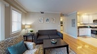 Located at 59A Garden Road in Peabody, Massachusetts, this single-floor residence offers a thoughtfully designed layout that balances comfort and functionality. The living room serves as the heart of the home, featuring warm hardwood flooring, crown molding, and sliding glass doors that invite natural light and provide outdoor access. The open sightline to the kitchen enhances the sense of space throughout the common areas.

The kitchen is equipped with white shaker-style cabinetry, dark granite countertops, tile flooring, and a full suite of stainless steel appliances, including a gas range, over-the-range microwave, and refrigerator. Recessed lighting adds a clean, polished finish.

The primary bedroom offers carpeted flooring, a window for natural light, and access to a spacious walk-in closet outfitted with wire shelving and hanging rods for ample storage. A second bedroom, also carpeted, features large windows that fill the room with daylight.

Two full bathrooms serve the unit, each featuring white vanities with dark granite countertops and tile flooring. One bathroom includes a walk-in shower, while the other offers additional storage with louvered cabinet doors.

Overall, the unit presents a clean, neutral aesthetic with consistent finishes throughout, creating a cohesive and comfortable living environment.