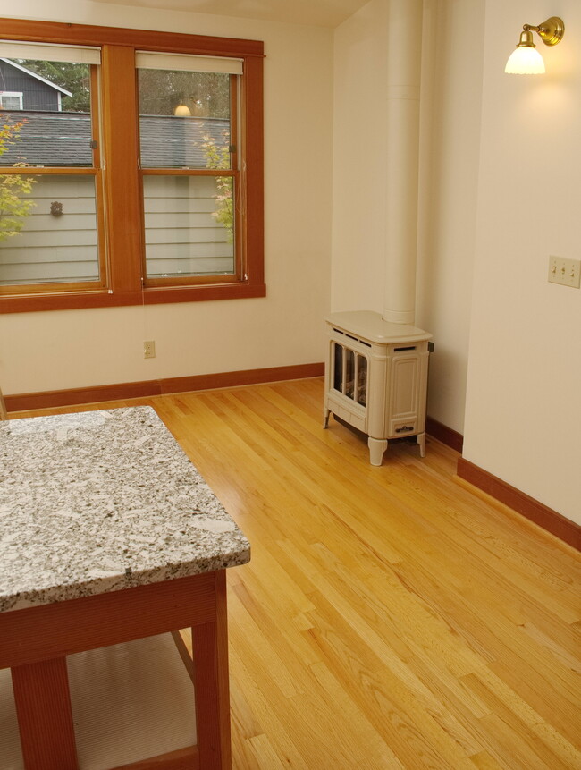 Island, heating stove, and dining area. - 701 N 76th St
