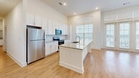This single-story, 3-bedroom, 2-bathroom home offers a thoughtfully designed layout that balances open communal spaces with comfortable private retreats. The heart of the home is a bright, open-concept kitchen and living area flooded with natural light from an abundance of large windows. The kitchen is well-equipped with crisp white cabinetry extending to the ceiling for generous storage, granite countertops, stainless steel appliances, and a central island featuring a built-in sink — ideal for both cooking and casual dining. A ceiling fan overhead and access to an outdoor area via French doors enhance the living space's airy, comfortable feel.

The primary bedroom is a spacious retreat featuring light hardwood flooring, tall ceilings, a ceiling fan, and multiple windows that invite natural light. Two additional bedrooms offer plush carpeting and natural light through well-sized windows. The two bathrooms are finished with granite-topped white vanities and hardwood-style flooring; one includes a full soaking tub and shower combination. Throughout the home, three closets — including a walk-in with wire shelving — provide excellent storage solutions. Consistent use of light hardwood flooring, neutral tones, and recessed lighting creates a clean, cohesive aesthetic throughout.