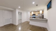 This 500 square foot apartment in Newport News, VA offers a well-designed living space on a single floor. The unit features one bedroom, measuring 120 square feet, providing a cozy retreat. The modern kitchen is a highlight, boasting light wood cabinetry, stainless steel appliances including a microwave and refrigerator, and elegant granite countertops. A kitchen island with a sink adds functionality and extra counter space. The kitchen floor features a distinctive speckled pattern, adding visual interest.

The bathroom is compact yet functional, with a white tub-shower combination, toilet, and simple fixtures. The bedroom, while modest in size, includes a ceiling fan for comfort and ample natural light. Neutral-toned carpeting in the bedroom and living areas creates a soft, inviting atmosphere. Throughout the apartment, crisp white walls and baseboards contribute to a clean, contemporary aesthetic. Recessed lighting and modern pendant fixtures in the kitchen provide well-distributed illumination.

Despite its compact size, the apartment's layout appears to maximize space efficiency, making it an ideal option for singles or couples seeking a low-maintenance living space in an urban setting.