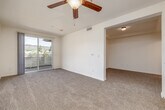 Located at 975 Woodland Parkway in San Marcos, CA, this well-appointed one-bedroom, one-bathroom residence offers a thoughtfully designed single-floor layout. The open-concept kitchen flows seamlessly into the living area, creating a connected and functional living space. The kitchen is equipped with warm honey-toned cabinetry, light countertops, stainless steel appliances including a refrigerator, electric range, microwave, and dishwasher, and is anchored by a peninsula that provides additional prep and seating space. Light wood-style flooring runs through the kitchen and entry areas, while plush carpeting extends through the living room and bedroom. The living room is bright and airy, featuring a ceiling fan and a sliding glass door that opens to a private balcony with pleasant outdoor views of the surrounding landscape. The generously sized primary bedroom includes a ceiling fan, a large closet with sliding mirror doors, and a window that brings in natural light and scenic views. The bathroom features wood-look tile flooring, a vanity with warm wood cabinetry, and a tub/shower combination equipped with safety grab bars for added accessibility.
